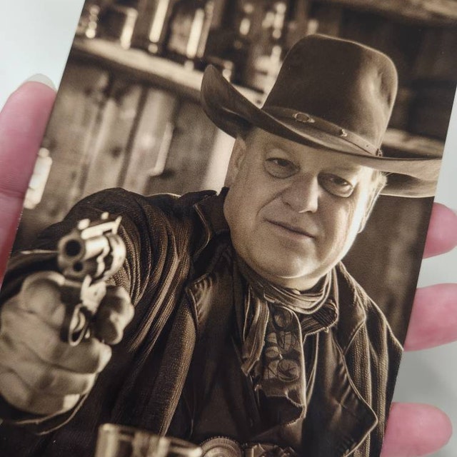 Sepia outlaw portrait held up to the camera